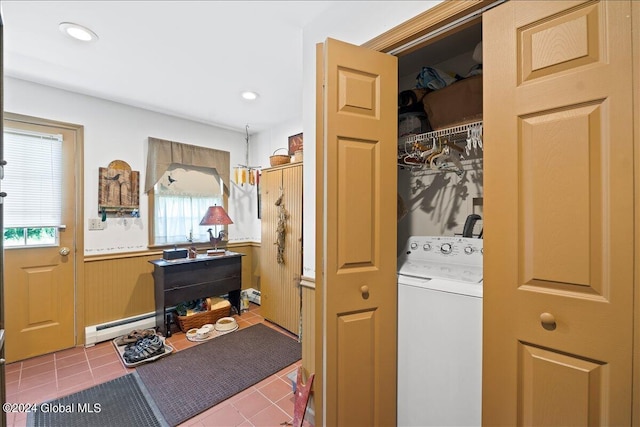 washroom featuring baseboard heating, tile patterned flooring, and washer / dryer