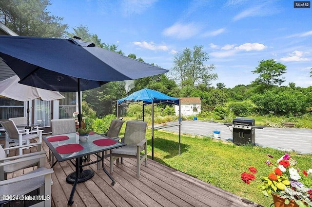 wooden deck featuring a lawn