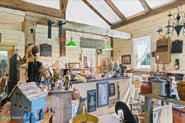 miscellaneous room with vaulted ceiling with beams and wood walls