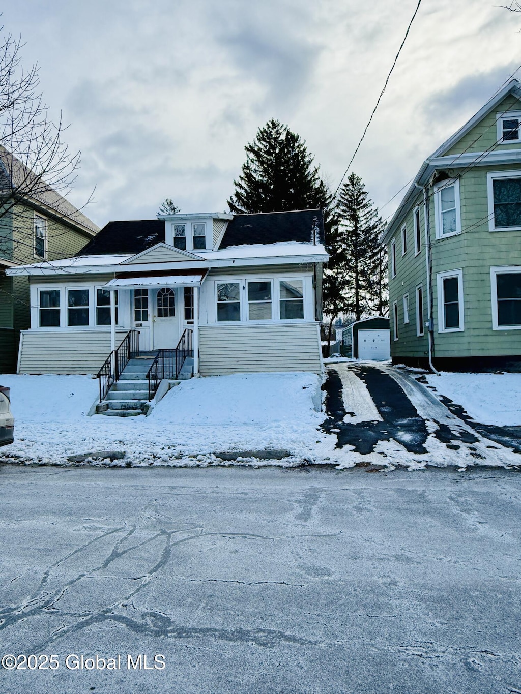 view of front of house featuring a garage and an outdoor structure