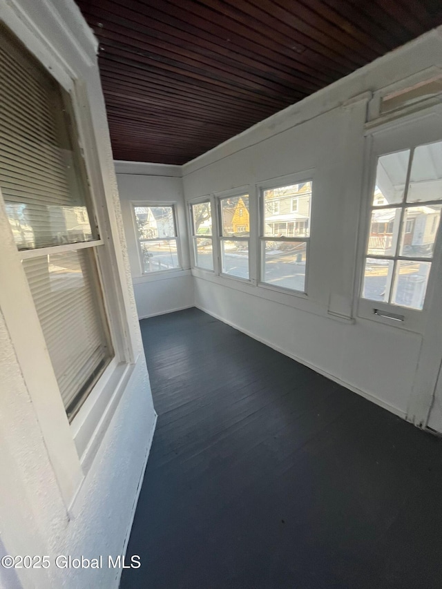 unfurnished sunroom with wood ceiling