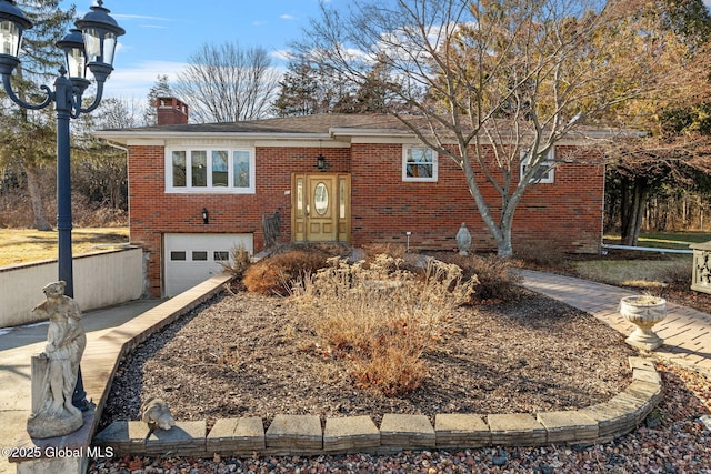 view of front facade featuring a garage, concrete driveway, brick siding, and a chimney