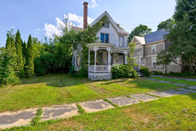 victorian-style house with covered porch and a front yard