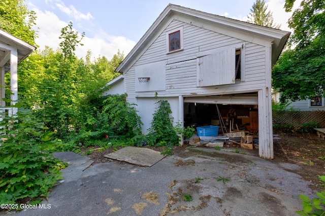 rear view of house featuring a garage