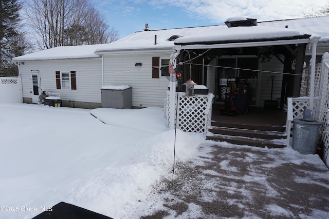 view of snow covered rear of property