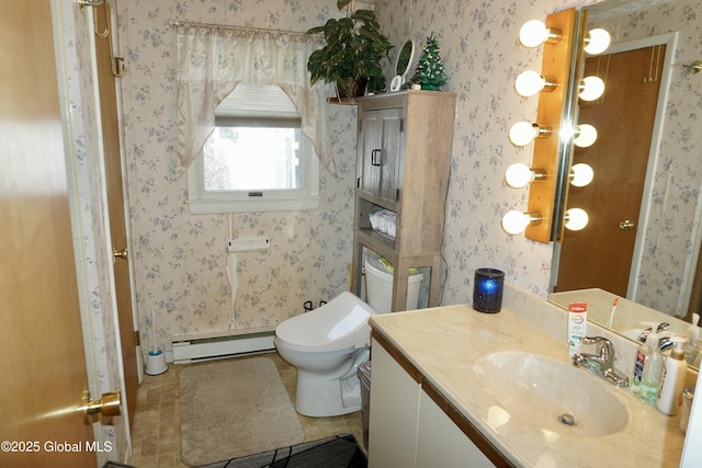 bathroom with baseboard heating, tile patterned floors, toilet, and vanity