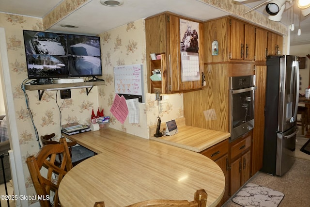 kitchen with ceiling fan and stainless steel appliances