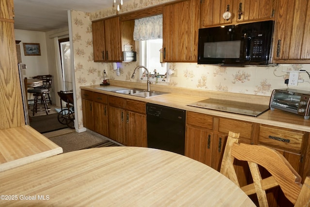 kitchen featuring sink and black appliances