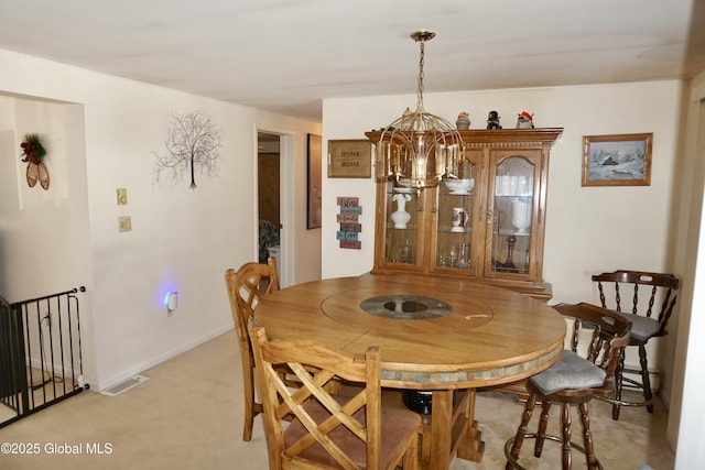 dining area featuring light carpet and a notable chandelier