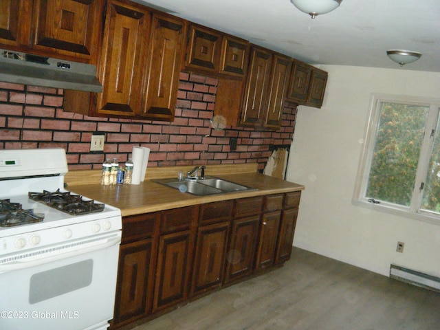 kitchen featuring light hardwood / wood-style flooring, baseboard heating, sink, and gas range gas stove