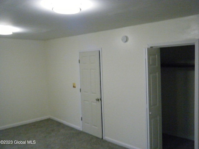 unfurnished bedroom with carpet floors and a closet