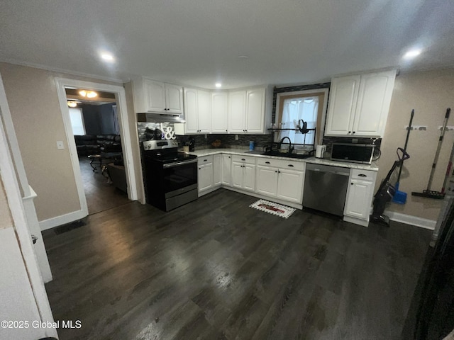 kitchen with sink, dark wood-type flooring, white cabinets, and appliances with stainless steel finishes