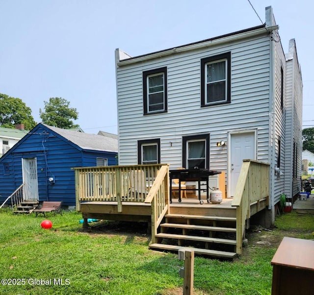 back of house with a yard and a deck