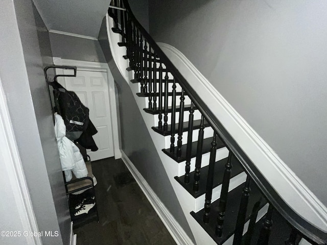 stairs featuring crown molding