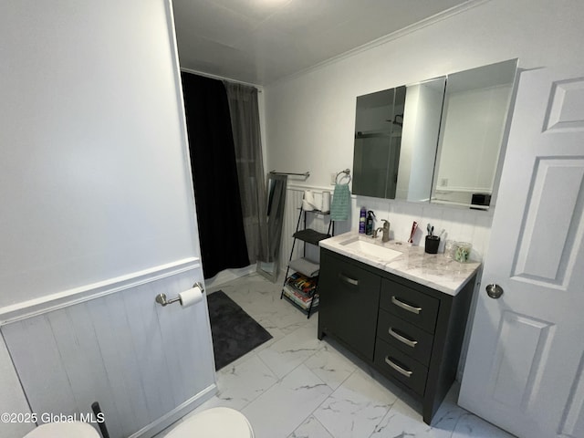 bathroom with crown molding, vanity, toilet, and a shower