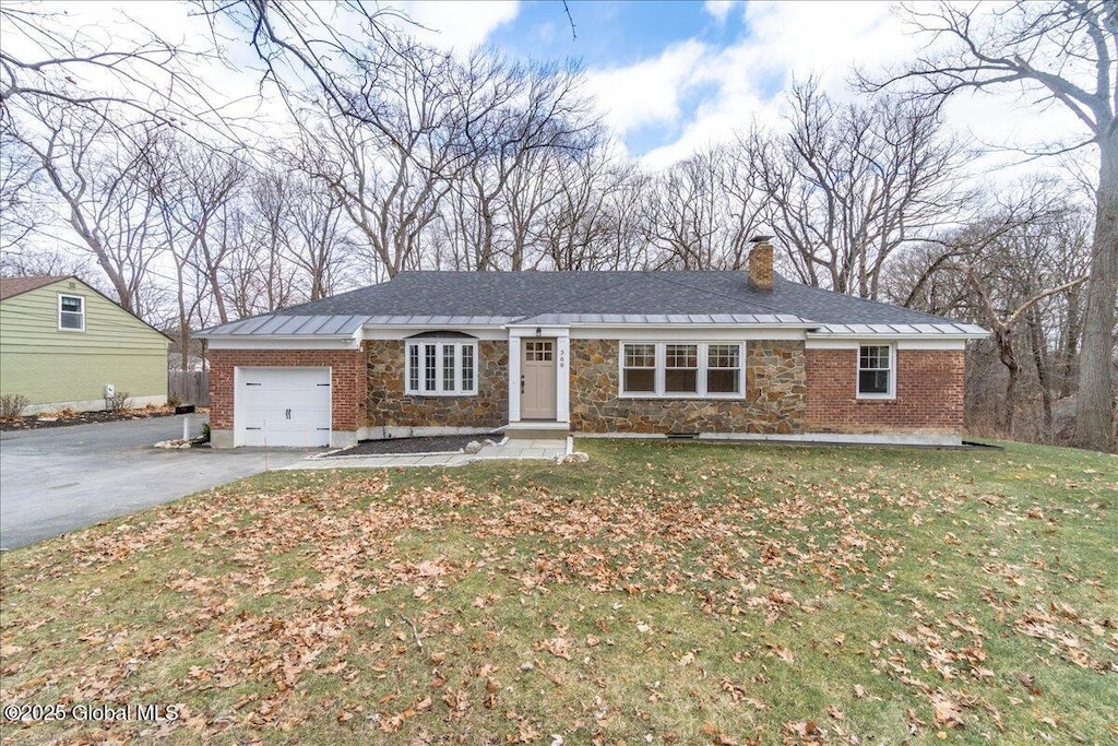 single story home with a front yard and a garage