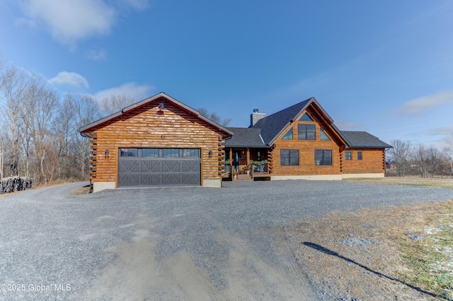 log home featuring a garage