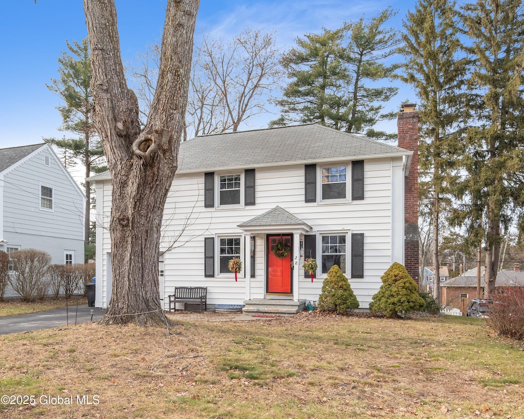 colonial home with a front lawn