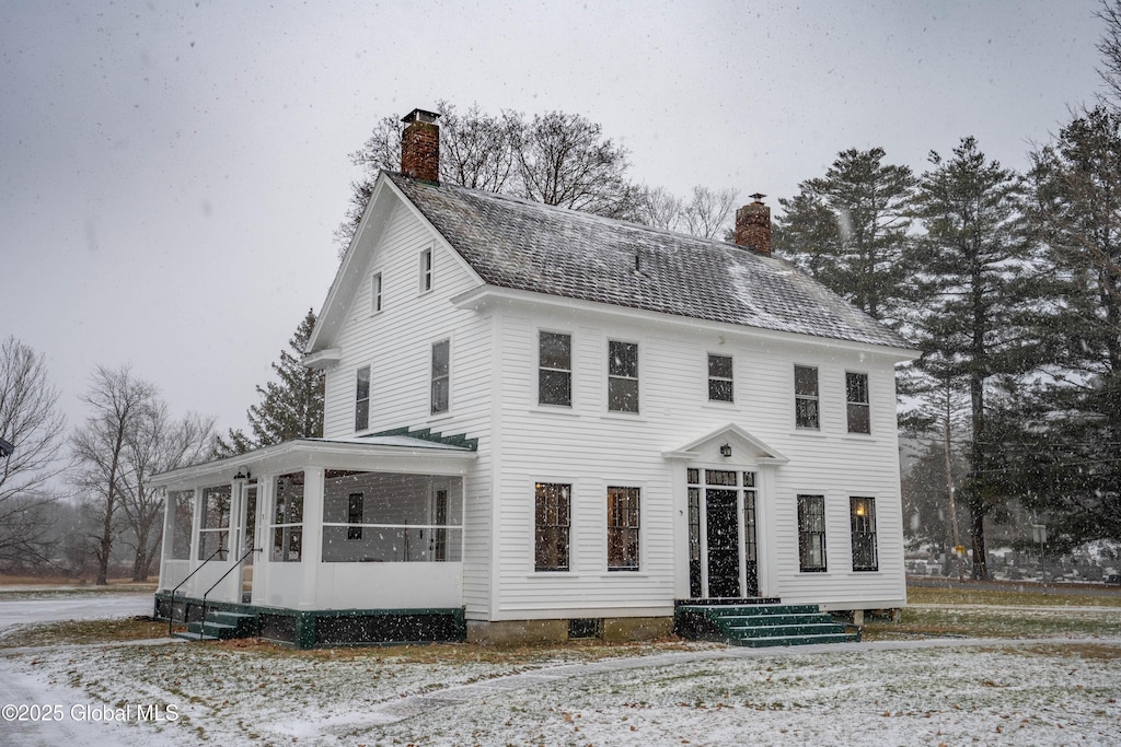 view of front of property with a sunroom