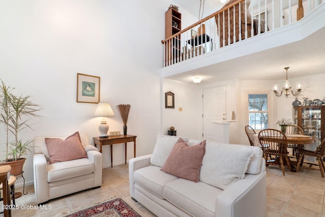 living room featuring a high ceiling, a chandelier, and light tile patterned flooring