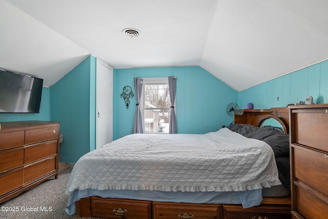 carpeted bedroom with lofted ceiling