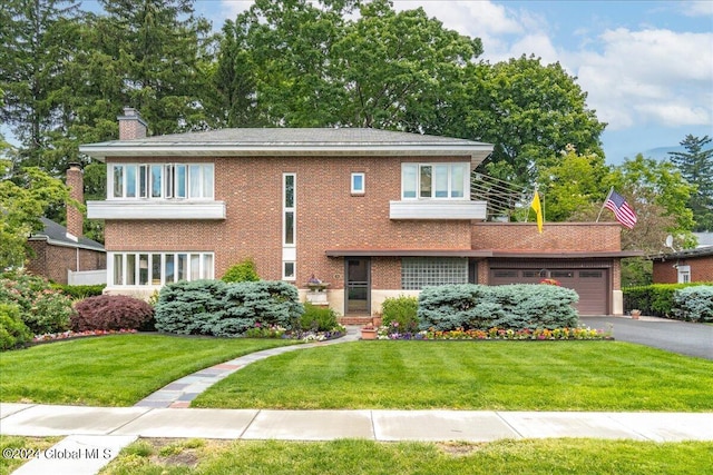 view of front facade with a front yard and a garage