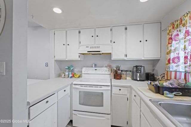 kitchen with white cabinets, electric range, and sink