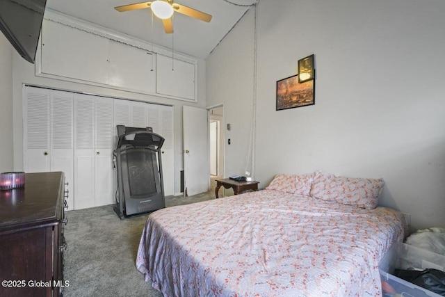 carpeted bedroom featuring a high ceiling, a closet, and ceiling fan