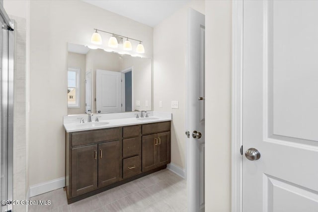 full bathroom featuring tile patterned floors, a sink, and double vanity