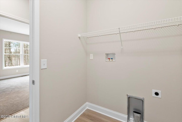 washroom with hookup for an electric dryer, laundry area, washer hookup, carpet flooring, and baseboards