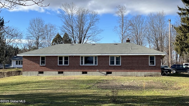 rear view of house with a yard