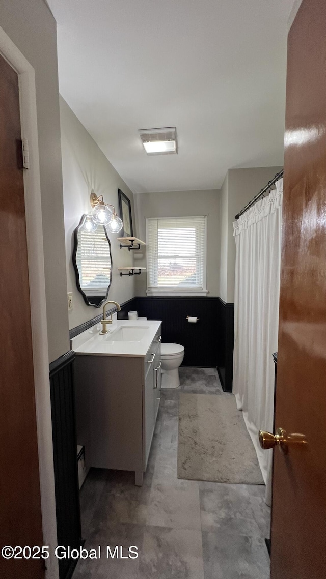 bathroom featuring vanity and toilet