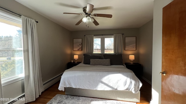 bedroom with a baseboard radiator, ceiling fan, and hardwood / wood-style flooring