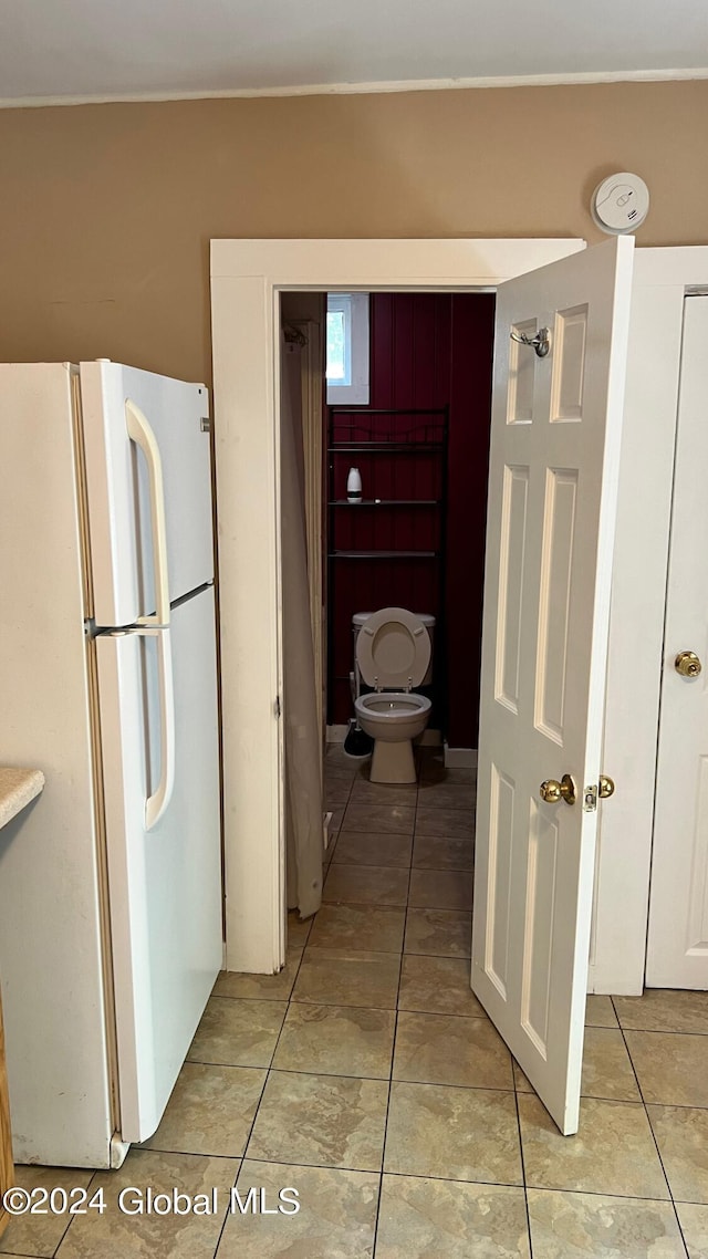 hallway with light tile patterned floors