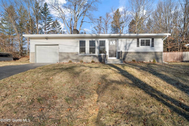 ranch-style home with a front lawn and a garage