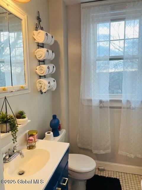 bathroom featuring tile patterned floors, vanity, and toilet