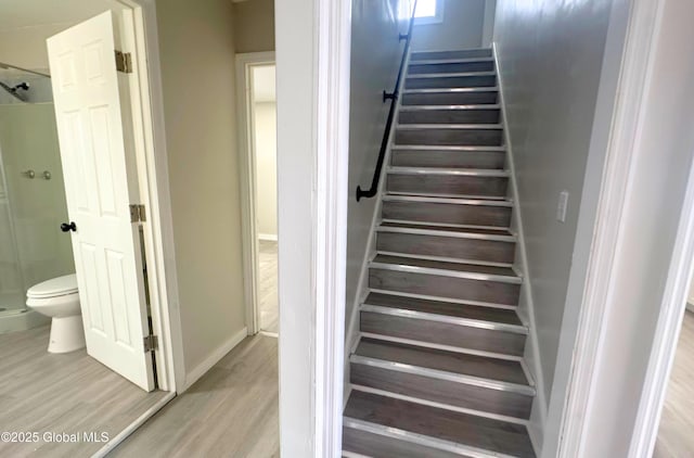 staircase with hardwood / wood-style flooring and wine cooler