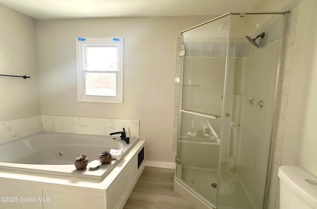 bathroom with hardwood / wood-style flooring, toilet, and independent shower and bath