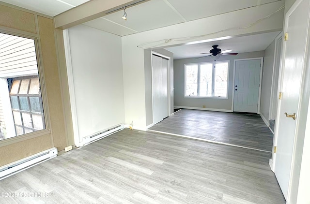 spare room with ceiling fan, light hardwood / wood-style floors, and baseboard heating