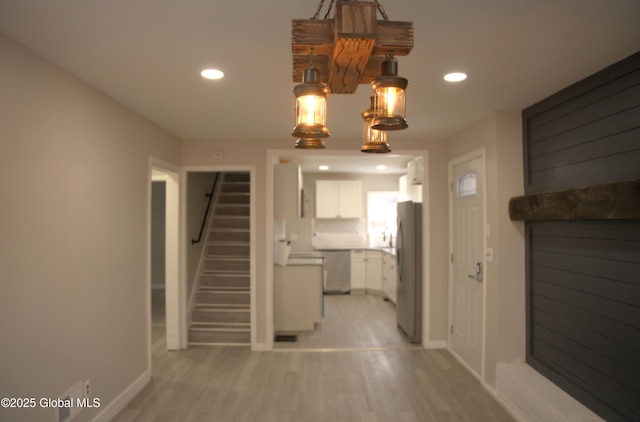 hall with light hardwood / wood-style floors