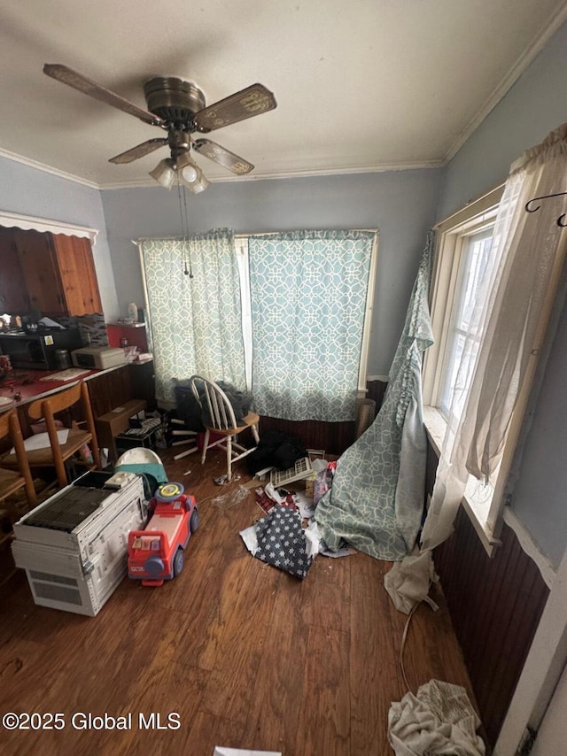 misc room featuring hardwood / wood-style floors, ceiling fan, and ornamental molding