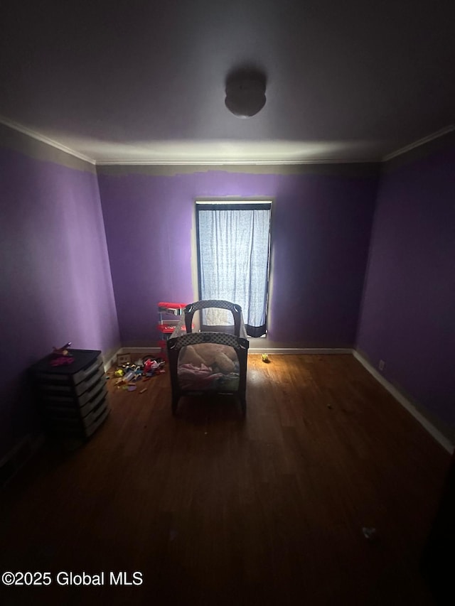 unfurnished bedroom with wood-type flooring and crown molding