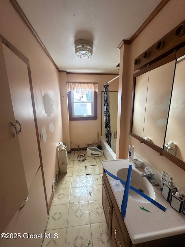 bathroom with vanity, shower / bath combination with curtain, and ornamental molding