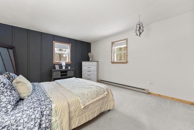 carpeted bedroom with a baseboard heating unit and multiple windows