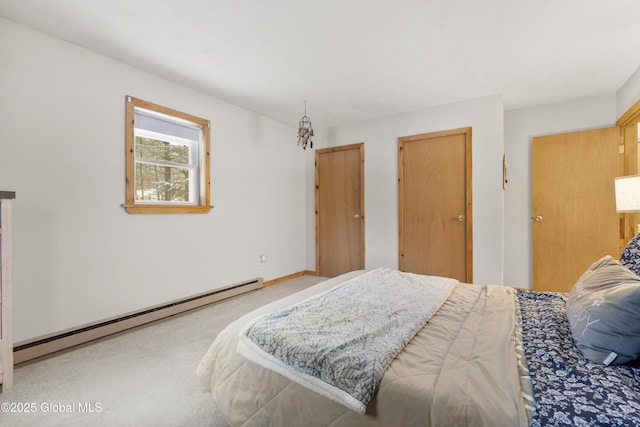 carpeted bedroom featuring a baseboard heating unit