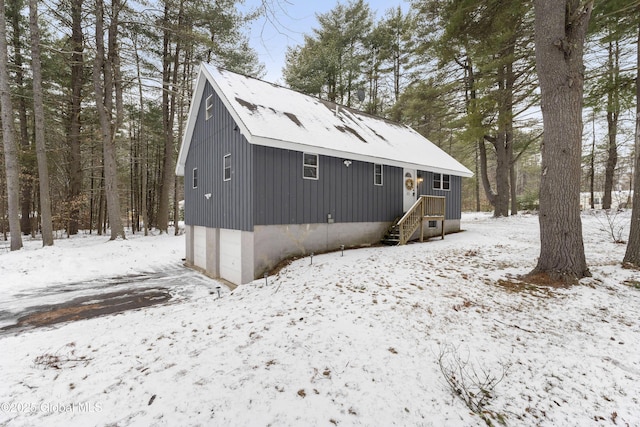 view of snow covered back of property