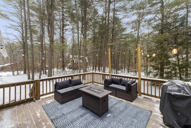 snow covered deck featuring an outdoor living space with a fire pit and a grill