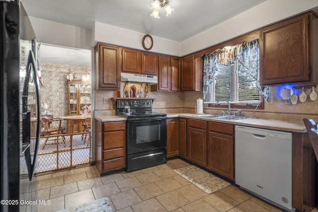 kitchen with sink, light tile patterned floors, and black appliances