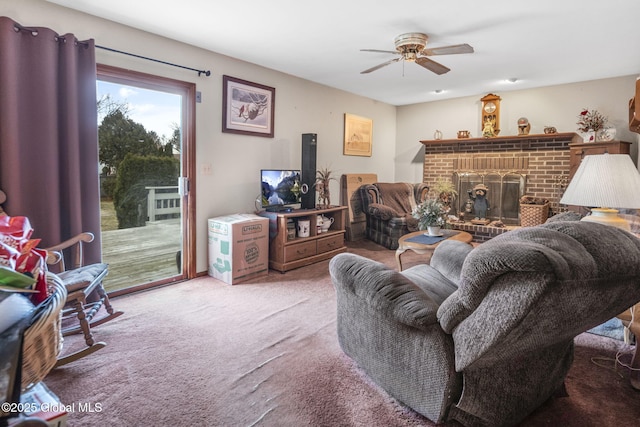 carpeted living room featuring ceiling fan and a fireplace