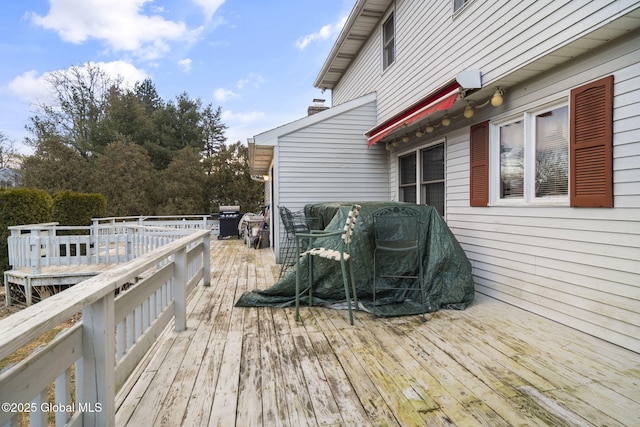 wooden terrace with area for grilling